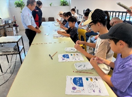 「集いステーション」で車の歴史について学ぶ参加者のみなさん